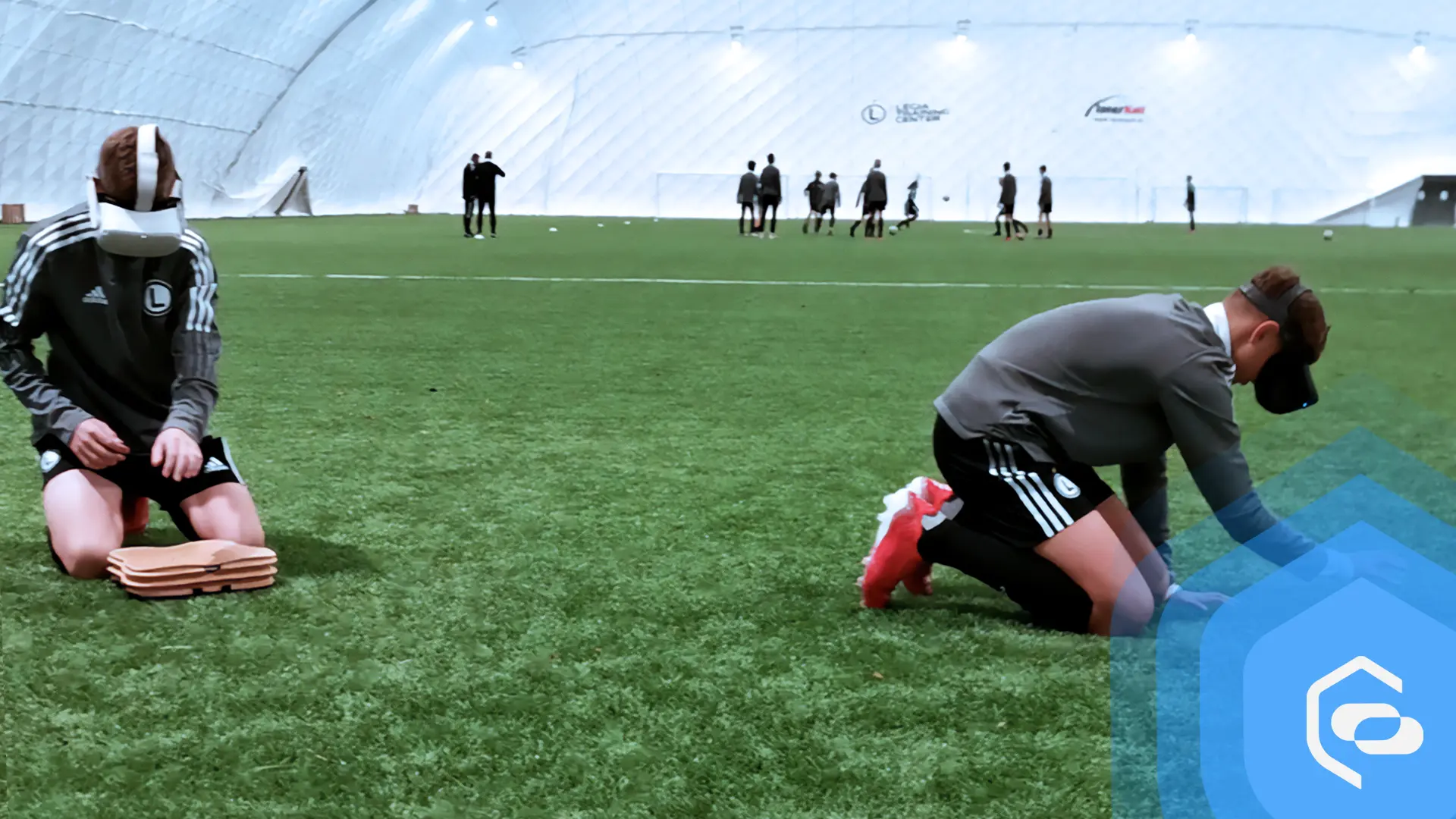Young football players learning first aid on a stadium using VR