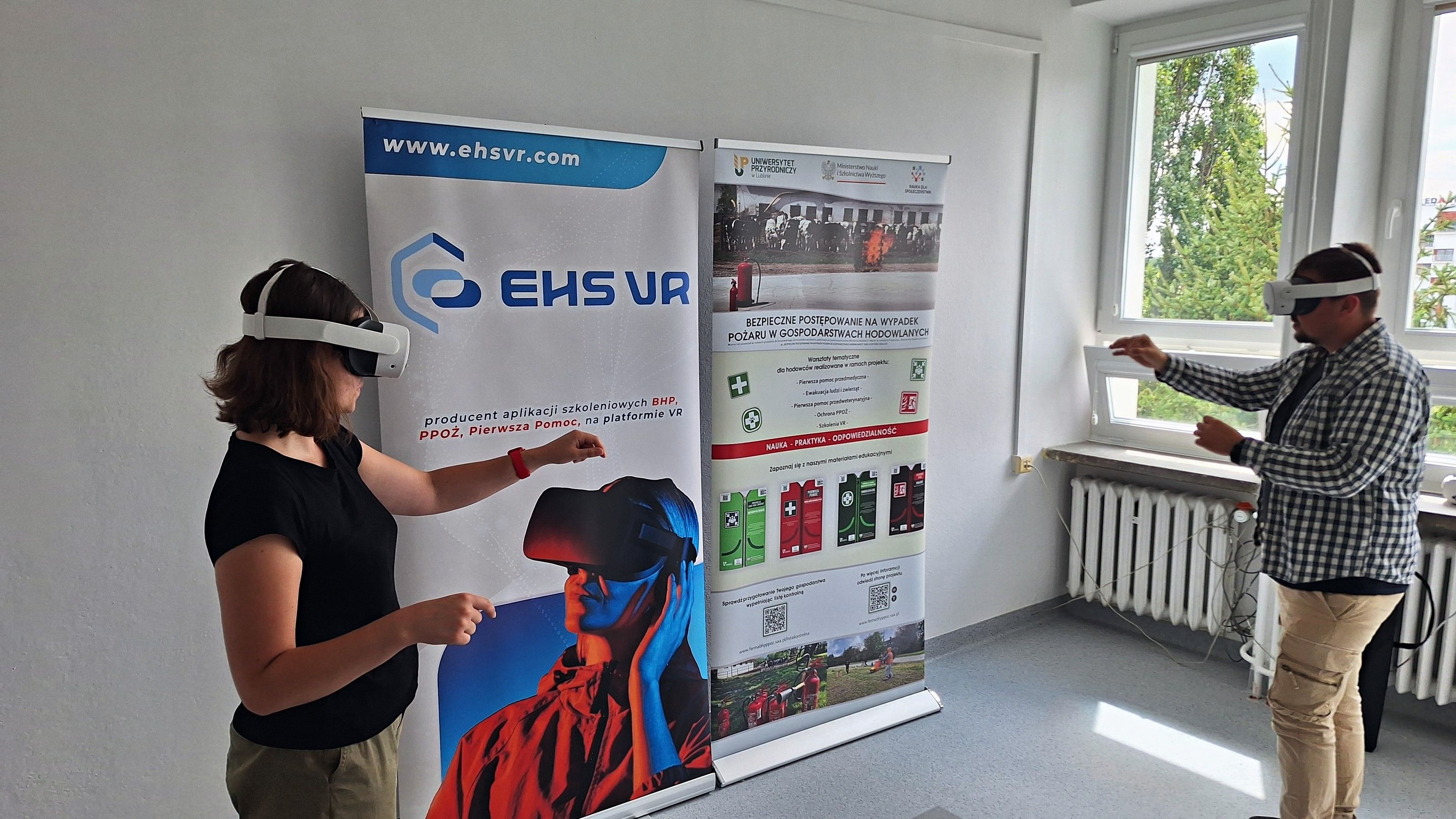 Two people trying EHS VR training on Meta Quest headsets in a university room