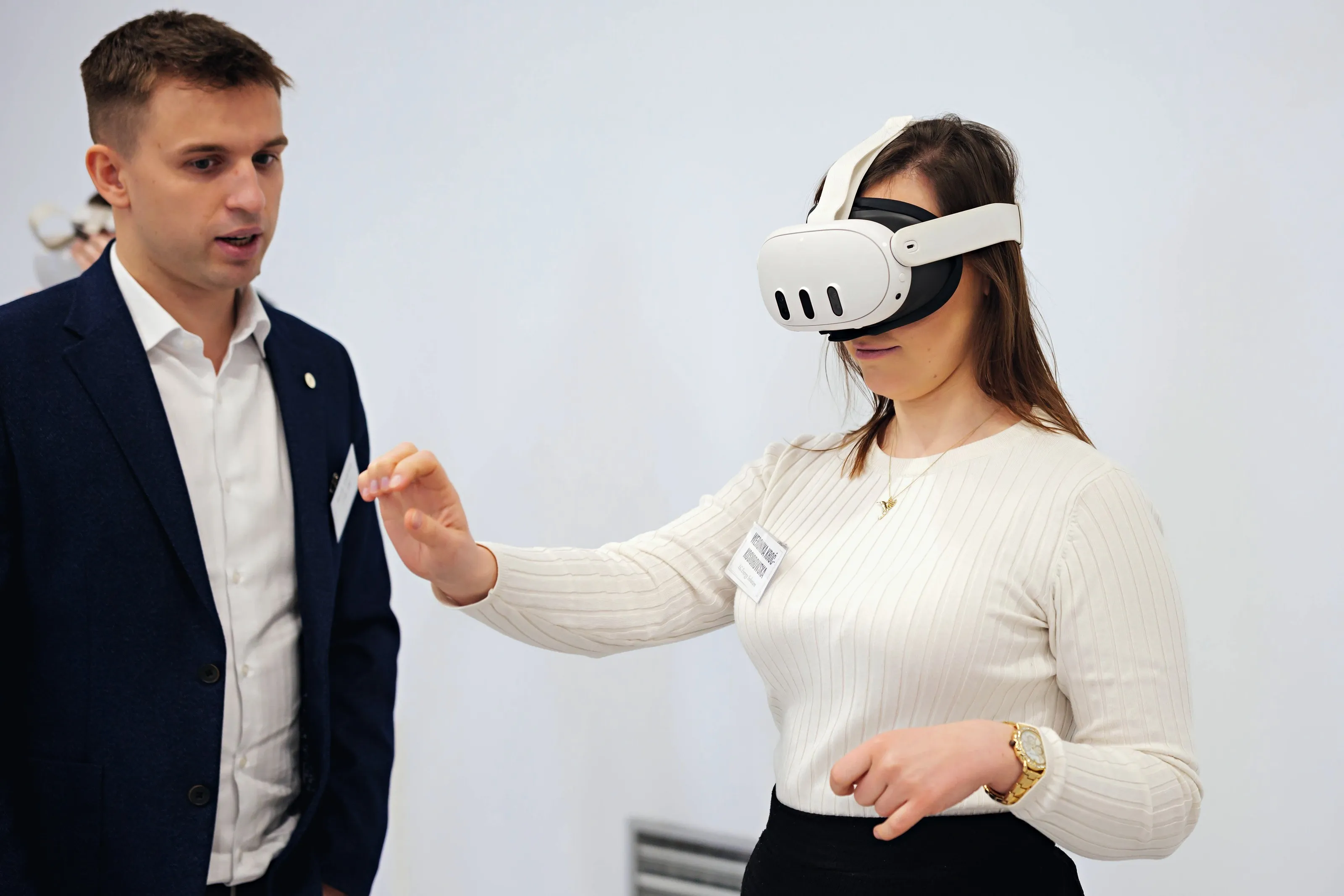A trainer guides a participant through her first VR exercise